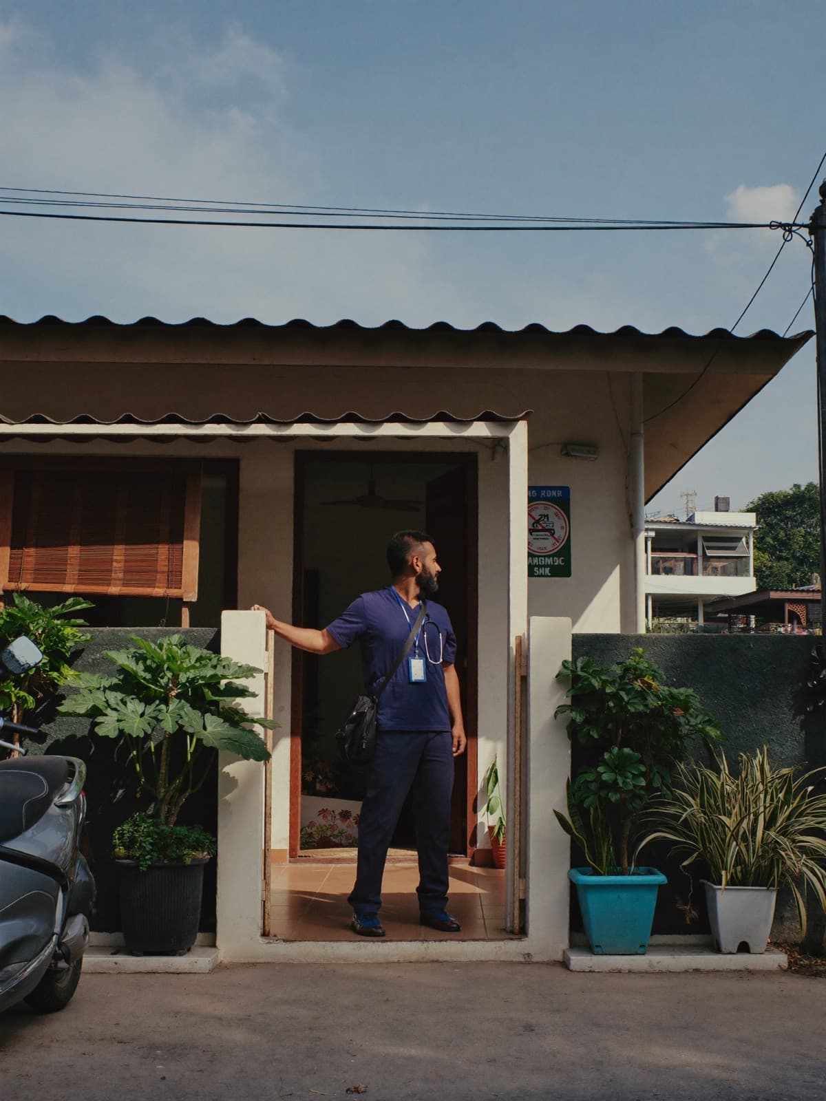 A physiotherapist arriving at a patient's home with his equipment bag